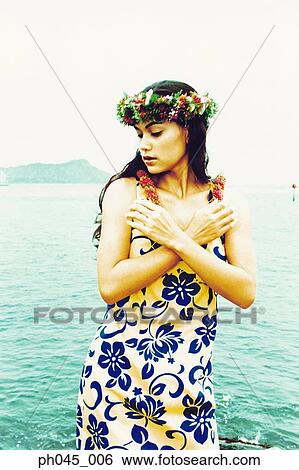 Stock Photograph - USA, Hawaii, female hula dancer performing near ocean . Fotosearch