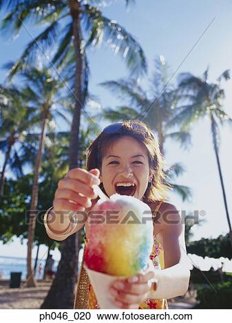 Young woman holding a cone of freeze View Large Photo Image Stock Image - Young woman holding a cone of freeze. Fotosearch