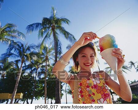 Young woman holding a cone of freeze View Large Photo Image Stock Photo - Young woman holding a cone of freeze. Fotosearch
