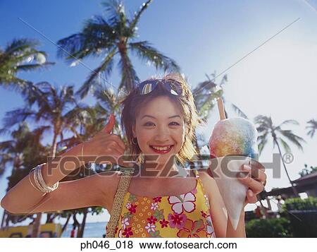 Young woman holding a cone of freeze View Large Photo Image Stock Photo - Young woman holding a cone of freeze. Fotosearch