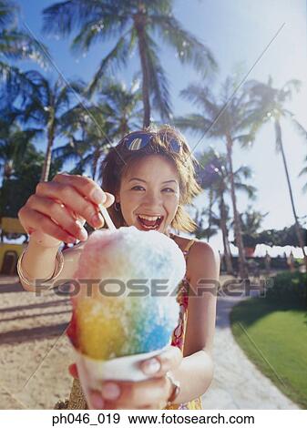 Young woman holding a cone of freeze View Large Photo Image Stock Photo - Young woman holding a cone of freeze. Fotosearch