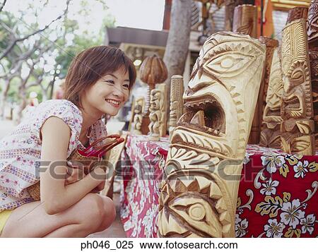 Young woman looking at Hawaiian handicraft View Large Photo Image Stock Photography - Young woman looking at Hawaiian handicraft. Fotosearch