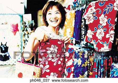 Young woman shopping for Hawaiian blouse View Large Photo Image Stock Photo - Young woman shopping for Hawaiian blouse. Fotosearch
