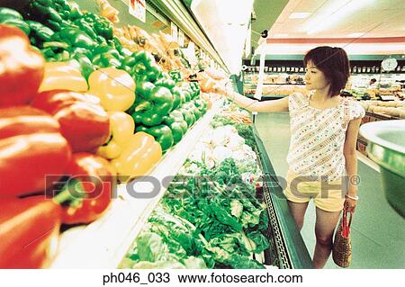 Young woman shopping for vegetables in fruit store View Large Photo Image Stock Image - Young woman shopping for vegetables in fruit store. Fotosearch
