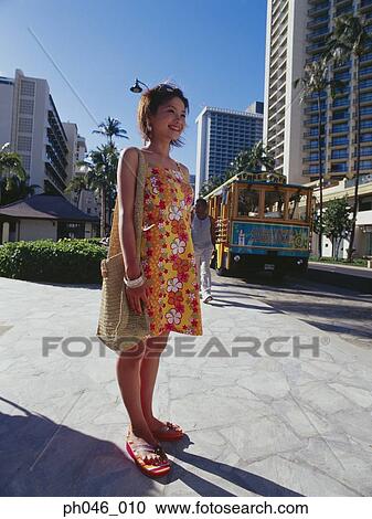 Young woman smiling, urban scene in background View Large Photo Image Stock Image - Young woman smiling, urban scene in background. Fotosearch