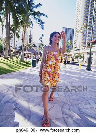 Young woman walking streets of Hawaii View Large Photo Image Stock Photo - Young woman walking streets of Hawaii. Fotosearch