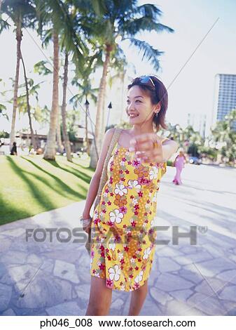 Young woman walking streets of Hawaii View Large Photo Image Stock Photo - Young woman walking streets of Hawaii. Fotosearch
