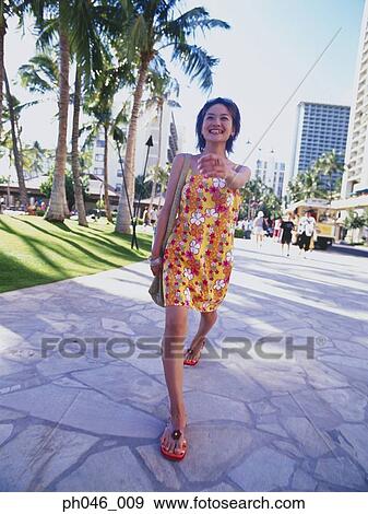 Young woman walking streets of Hawaii View Large Photo Image Stock Photo - Young woman walking streets of Hawaii. Fotosearch
