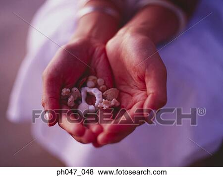 Woman's hands holding pebbles and stones, close-up View Large Photo Image Stock Photo - Woman's hands holding pebbles and stones, close-up . Fotosearch