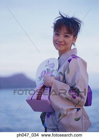 Young woman in Japanese kimono at a beach, portrait View Large Photo Image Picture - Young woman in Japanese kimono at a beach, portrait. Fotosearch