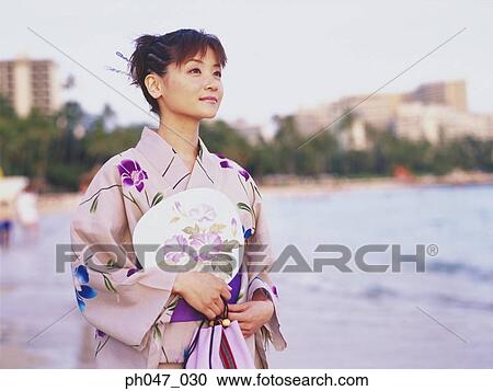 Young woman in Japanese kimono at a beach, portrait View Large Photo Image Stock Image - Young woman in Japanese kimono at a beach, portrait. Fotosearch