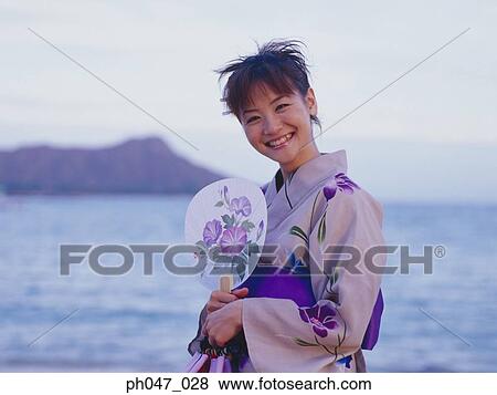 Young woman in Japanese kimono at a beach, portrait View Large Photo Image Stock Photo - Young woman in Japanese kimono at a beach, portrait. Fotosearch