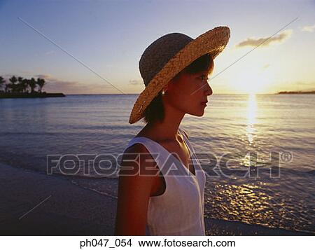 Young woman in straw hat at sunset, portrait View Large Photo Image Picture - Young woman in straw hat at sunset, portrait. Fotosearch