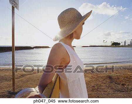Young woman in straw hat, portrait View Large Photo Image Stock Photography - Young woman in straw hat, portrait. Fotosearch
