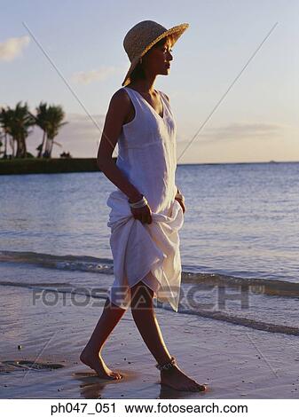 Young woman in straw hat walking on the beach, portrait View Large Photo Image Stock Image - Young woman in straw hat walking on the beach, portrait. Fotosearch