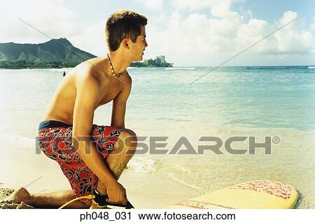 Surfer getting ready to surf View Large Photo Image Stock Image - Surfer getting ready to surf. Fotosearch