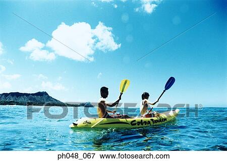 Stock Photo - Young couple Kayaking . Fotosearch