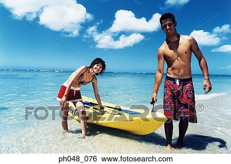 Young couple pulling kayak to shore View Large Photo Image Stock Photograph - Young couple pulling kayak to shore. Fotosearch