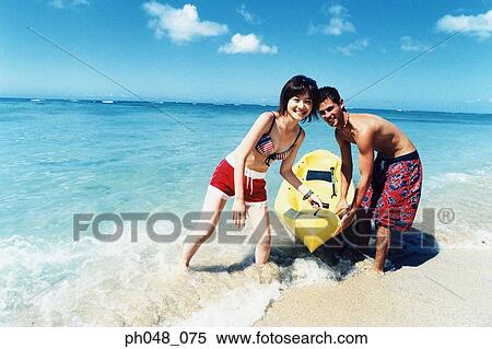 Young couple pulling kayak to shore View Large Photo Image Stock Photography - Young couple pulling kayak to shore. Fotosearch