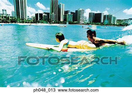 Young couple surfing, Hawaii beach View Large Photo Image Stock Image - Young couple surfing, Hawaii beach. Fotosearch