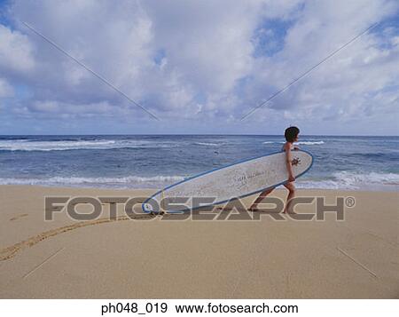 Young woman dragging surfboard on beach View Large Photo Image Stock Photo - Young woman dragging surfboard on beach. Fotosearch