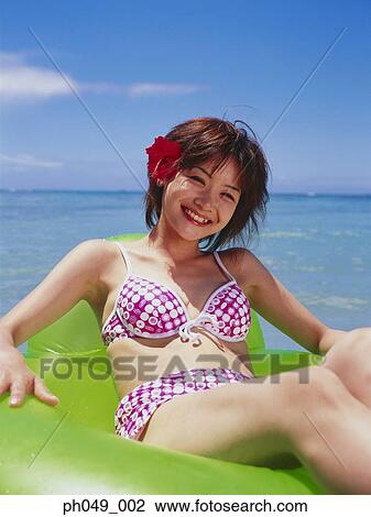Young woman floating in water on inflatable ring View Large Photo Image Stock Image - Young woman floating in water on inflatable ring . Fotosearch