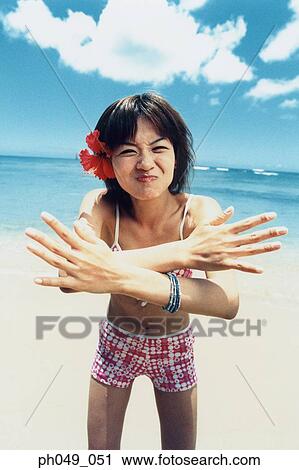 Young woman in bikini at a beach, arms crossed, portrait View Large Photo Image Stock Image - Young woman in bikini at a beach, arms crossed, portrait. Fotosearch