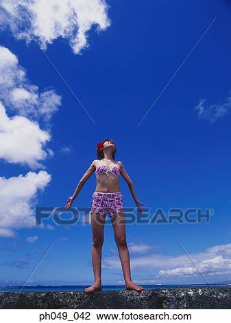 Young woman in bikini at a water breaker View Large Photo Image Stock Image - Young woman in bikini at a water breaker. Fotosearch