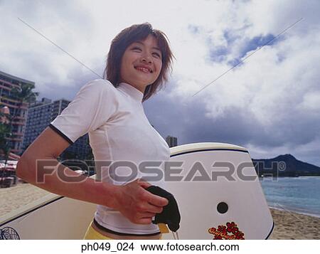 Picture - Young woman with paddleboard, portrait. Fotosearch