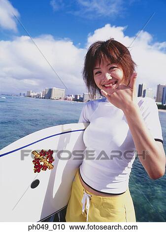Stock Image - Young woman with paddleboard, portrait. Fotosearch