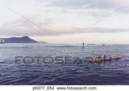 Men canoeing in the ocean, view of Diamond Head, Hawaii View Large Photo Image Picture - Men canoeing in the ocean, view of Diamond Head, Hawaii. Fotosearch