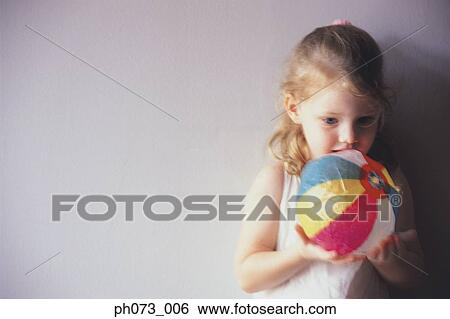 Portrait of a girl holding a ball View Large Photo Image Stock Photograph - Portrait of a girl holding a ball. Fotosearch