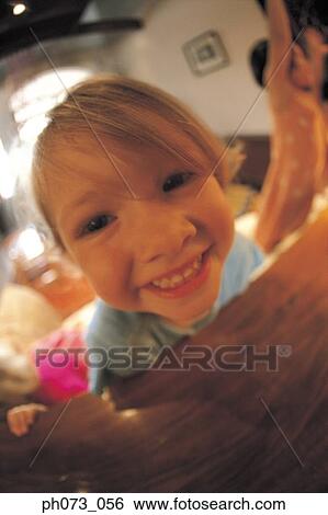 Portrait of a young girl smiling View Large Photo Image Stock Photograph - Portrait of a young girl smiling. Fotosearch