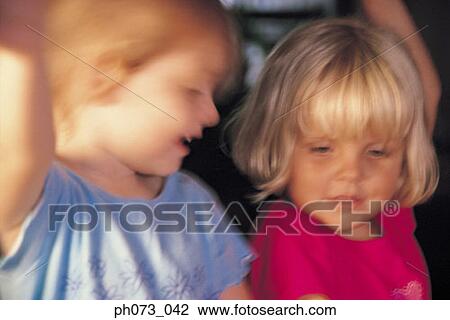 Stock Image - Portrait of two young girls playing. Fotosearch