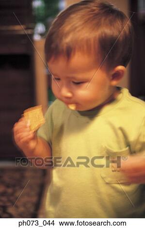 Young boy eating cracker View Large Photo Image Picture - Young boy eating cracker. Fotosearch