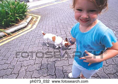 Stock Image - Young girl and pet dog. Fotosearch