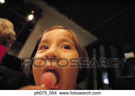 Young girl eating lollipop View Large Photo Image Picture - Young girl eating lollipop . Fotosearch