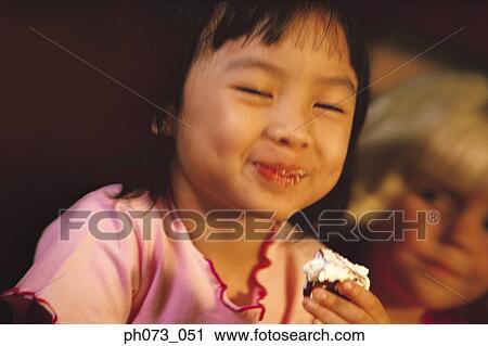 Young girl enjoying her cake View Large Photo Image Stock Image - Young girl enjoying her cake. Fotosearch