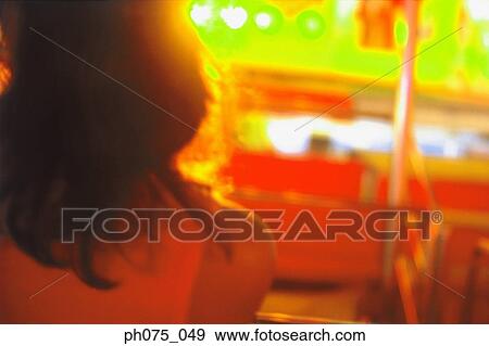 Rear view of young woman in carnival View Large Photo Image Stock Photo - Rear view of young woman in carnival. Fotosearch