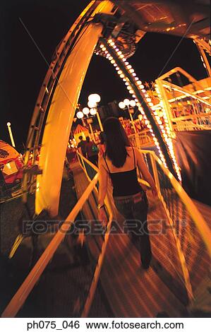 Rear view of young woman in carnival View Large Photo Image Stock Photograph - Rear view of young woman in carnival. Fotosearch