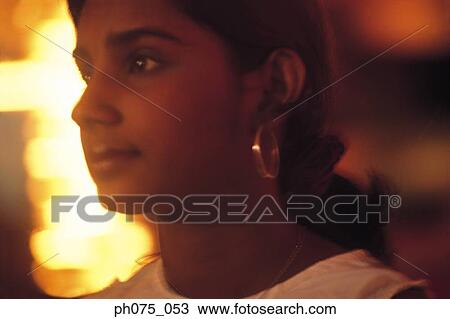 Stock Image - Side view of young Indian woman. Fotosearch