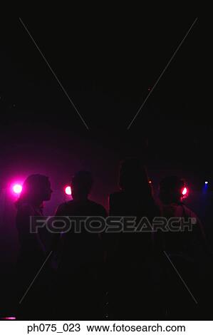 Stock Image - Silhouette of young woman in nightclub. Fotosearch