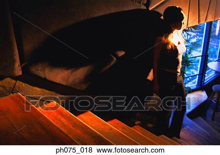 Silhouette of young woman standing by stairs View Large Photo Image Stock Photo - Silhouette of young woman standing by stairs. Fotosearch