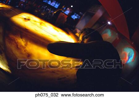 Stock Image - Young woman resting head on bar counter. Fotosearch