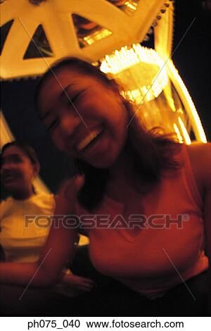 Young women at amusement park laughing View Large Photo Image Stock Image - Young women at amusement park laughing. Fotosearch