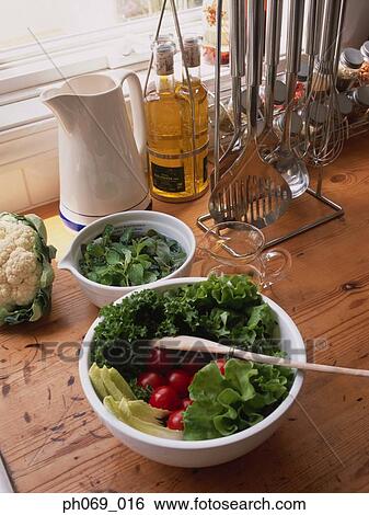 Bowl of salad and ingredients on kitchen table View Large Photo Image Stock Photograph - Bowl of salad and ingredients on kitchen table. Fotosearch