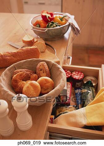 Bread in Basket, sieve of vegetables on kitchen table View Large Photo Image Stock Photo - Bread in Basket, sieve of vegetables on kitchen table. Fotosearch