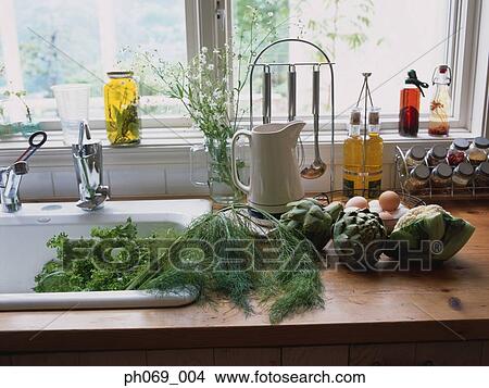 Food items and ingredients at kitchen sink area View Large Photo Image Picture - Food items and ingredients at kitchen sink area. Fotosearch