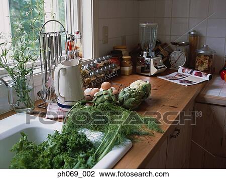 Food items and ingredients at kitchen sink area View Large Photo Image Stock Image - Food items and ingredients at kitchen sink area. Fotosearch