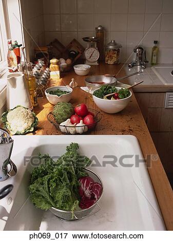 Food items and ingredients at kitchen sink area View Large Photo Image Stock Photo - Food items and ingredients at kitchen sink area. Fotosearch